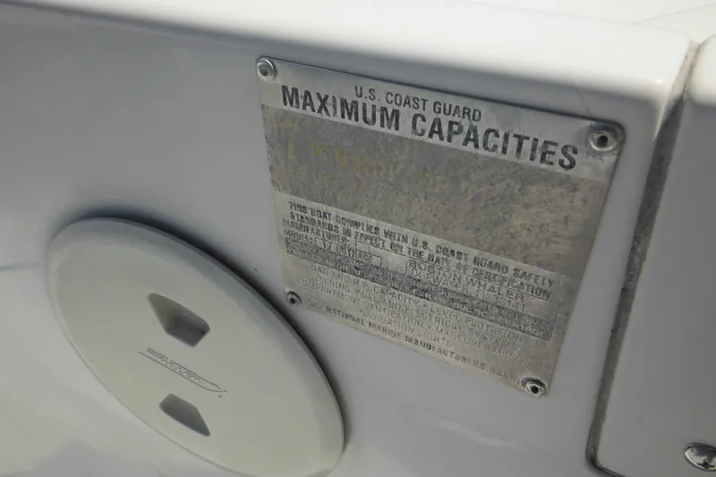 Slide: The Image of 1996 Boston Whaler Outrage 17 capacity plate, U.S. Coast Guard compliance details. - 16