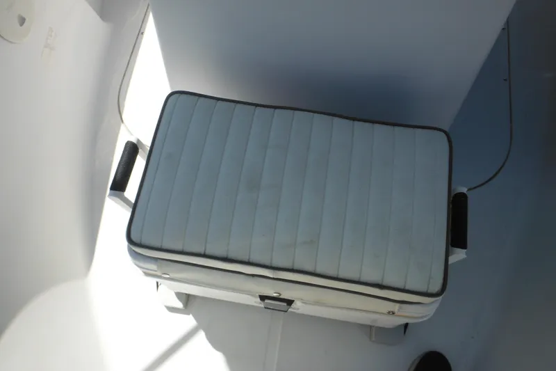 Slide: The Image of Cushioned seat on 1996 Boston Whaler Outrage 17 boat, featuring white upholstery and handles. - 19