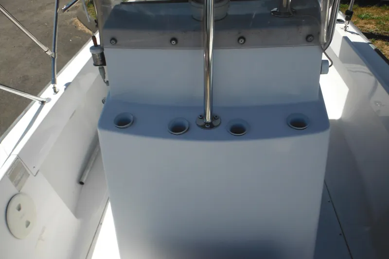 Slide: The Image of 1996 Boston Whaler Outrage 17 console with rod holders and stainless steel rail. - 20