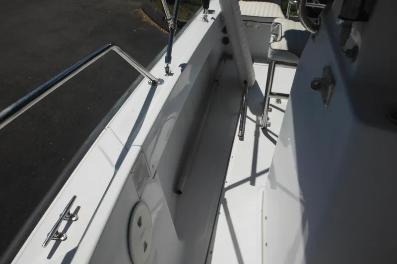 Slide: The Image of 1996 Boston Whaler Outrage 17 interior with stainless steel railings and seating. - 22