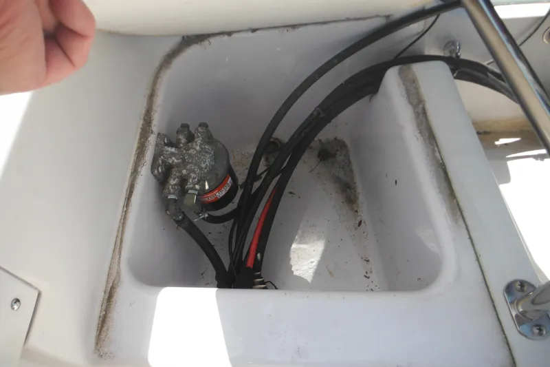 Slide: The Image of 1996 Boston Whaler Outrage 17 boat compartment with wiring and components. - 30