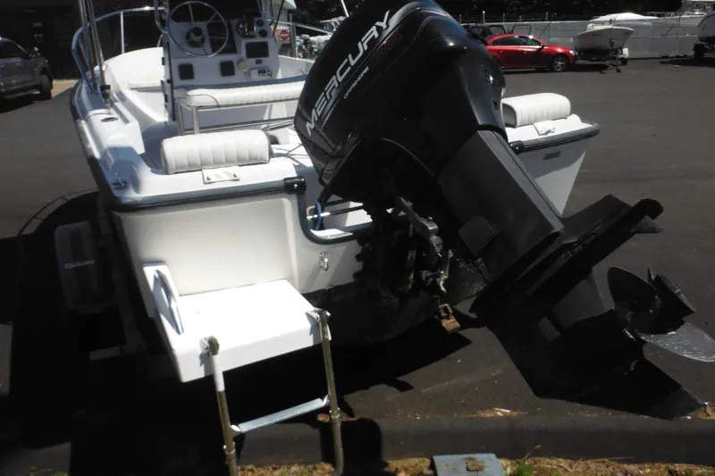 Slide: The Image of 1996 Boston Whaler Outrage 17 with Mercury outboard motor, parked on pavement. - 5
