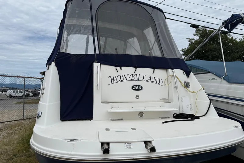 Slide: The Image of 2008 Rinker 260 Express Cruiser boat with covered deck, docked at marina. - 12