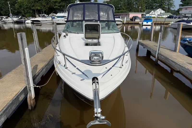 Slide: The Image of 2008 Rinker 260 Express Cruiser docked at marina, front view. - 2