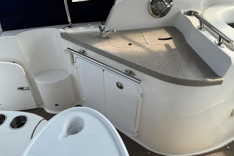 Slide: The Image of 2008 Rinker 260 Express Cruiser interior with sink and storage area. - 4