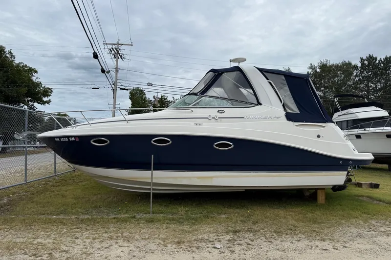 Slide: The Image of 2008 Rinker 260 Express Cruiser boat on display outdoors. - 9