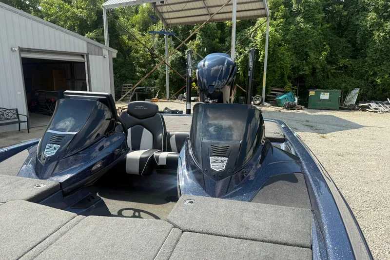 Slide: The Image of 2020 Skeeter ZX225 boat parked outdoors near a metal building. - 4