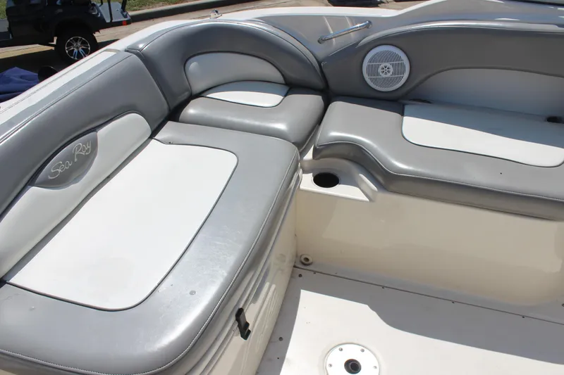 Slide: The Image of 2006 Sea Ray 270 Sundeck interior with gray and white seating, speaker, and cup holder. - 11