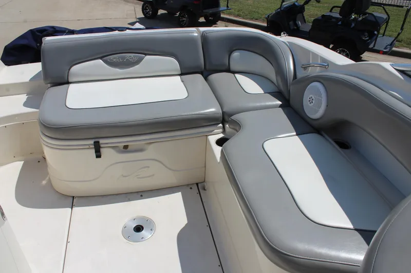 Slide: The Image of 2006 Sea Ray 270 Sundeck interior with gray and white seating, featuring a built-in speaker. - 12