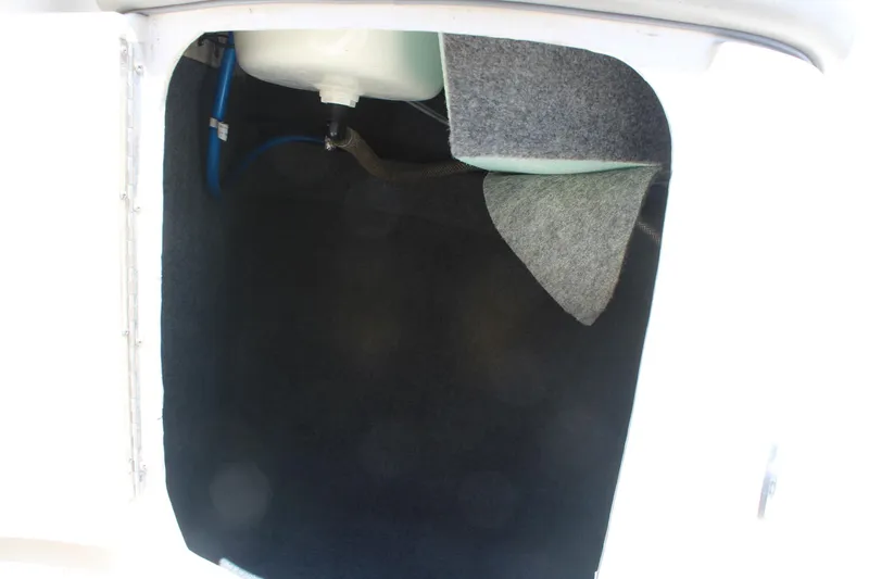 Slide: The Image of Storage compartment of a 2006 Sea Ray 270 Sundeck boat, featuring interior carpeting. - 14