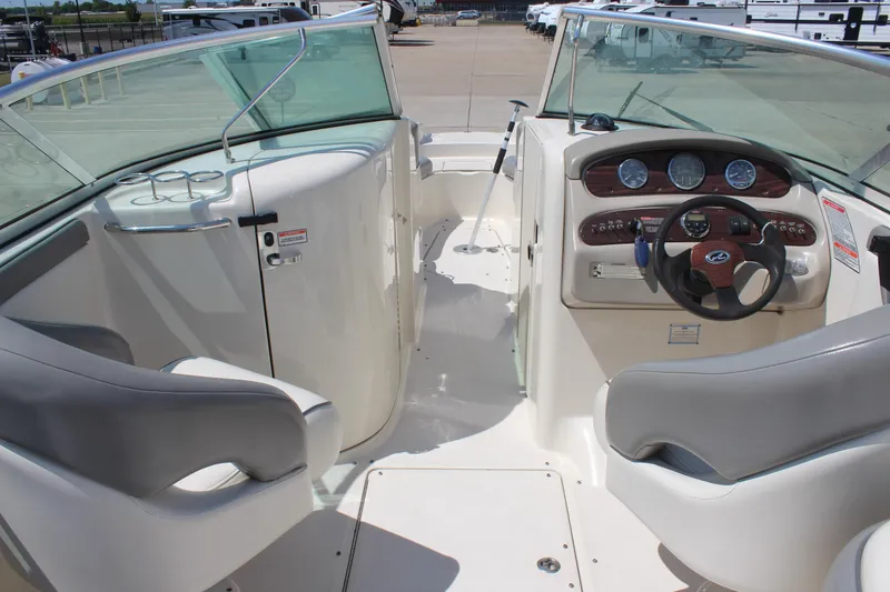 Slide: The Image of 2006 Sea Ray 270 Sundeck interior with steering wheel, dashboard, and seating. - 15