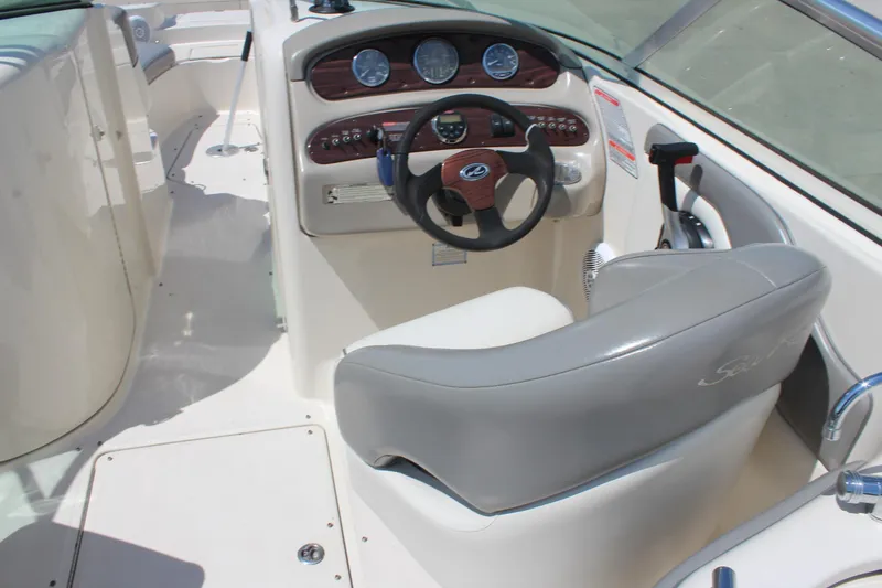 Slide: The Image of 2006 Sea Ray 270 Sundeck boat cockpit with steering wheel and control panel. - 17