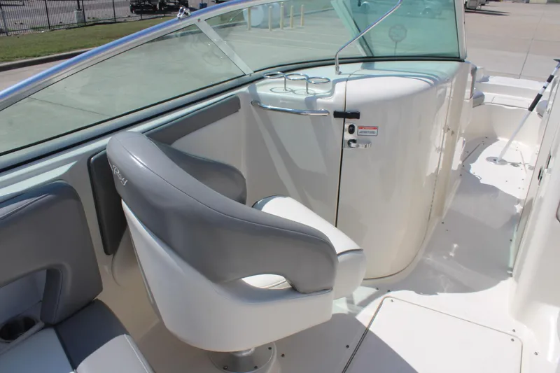 Slide: The Image of 2006 Sea Ray 270 Sundeck interior with gray seating and sleek white console. - 18