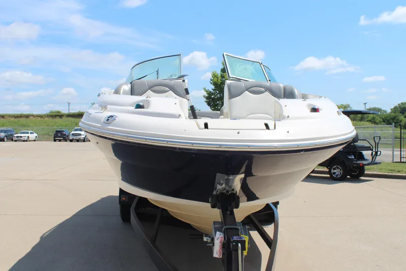 Slide: The Image of 2006 Sea Ray 270 Sundeck boat on trailer under clear blue sky. - 2