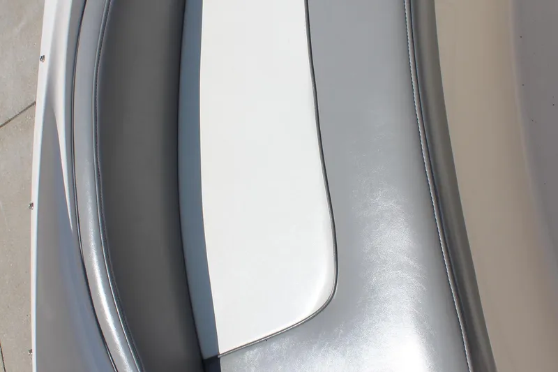 Slide: The Image of Close-up of 2006 Sea Ray 270 Sundeck boat seating with gray and white upholstery. - 21