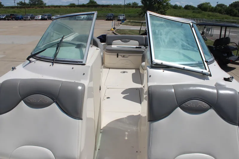 Slide: The Image of 2006 Sea Ray 270 Sundeck boat interior with open windshield and seating area. - 25