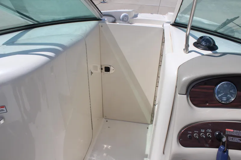Slide: The Image of 2006 Sea Ray 270 Sundeck helm with gauges and controls, showcasing sleek design. - 28