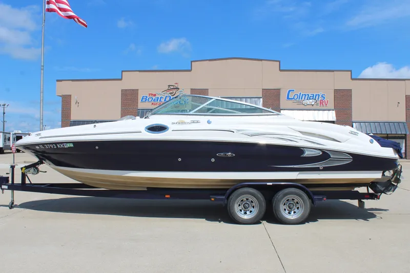 Slide: The Image of 2006 Sea Ray 270 Sundeck boat on trailer, parked outside dealership. - 4