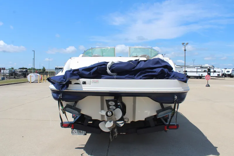 Slide: The Image of 2006 Sea Ray 270 Sundeck boat, rear view, parked on concrete under blue sky. - 6