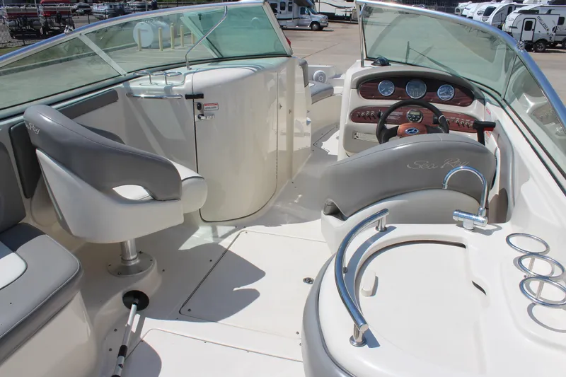 Slide: The Image of 2006 Sea Ray 270 Sundeck interior with helm, seating, and dashboard controls. - 8