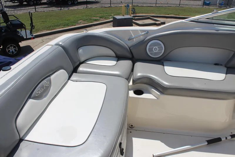 Slide: The Image of 2006 Sea Ray 270 Sundeck interior with gray and white seating, speaker, and cup holder. - 9