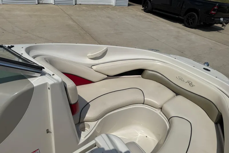 Slide: The Image of 2004 Sea Ray 200 Select boat interior with cream leather seating and cup holders. - 10