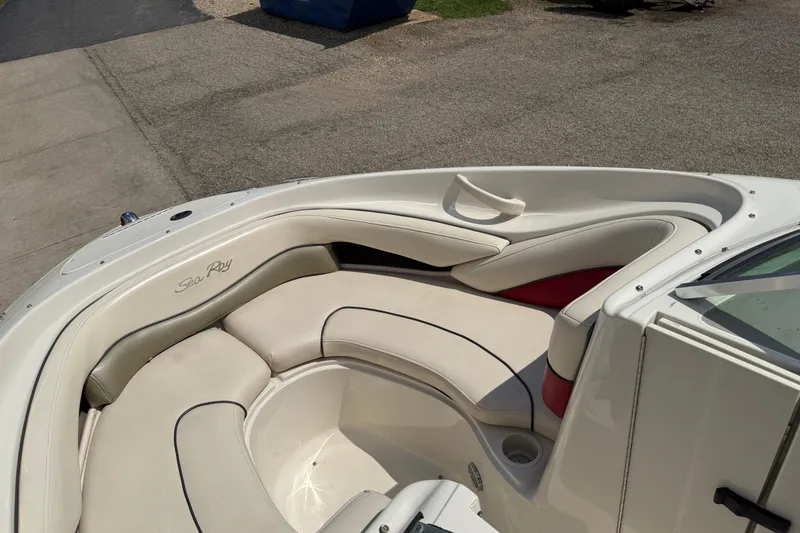 Slide: The Image of 2004 Sea Ray 200 Select boat interior with white cushioned seating. - 11