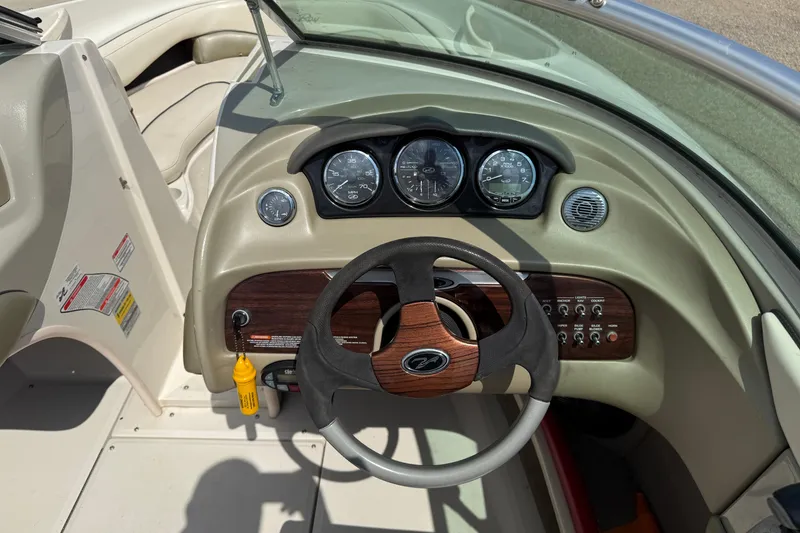 Slide: The Image of 2004 Sea Ray 200 Select boat dashboard with steering wheel and instrument panel. - 16