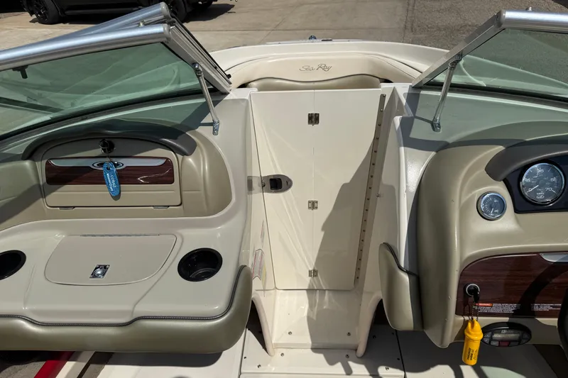 Slide: The Image of 2004 Sea Ray 200 Select boat interior with dashboard and seating area. - 20