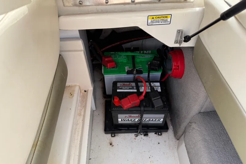 Slide: The Image of Battery compartment of a 2004 Sea Ray 200 Select boat, featuring dual batteries. - 25