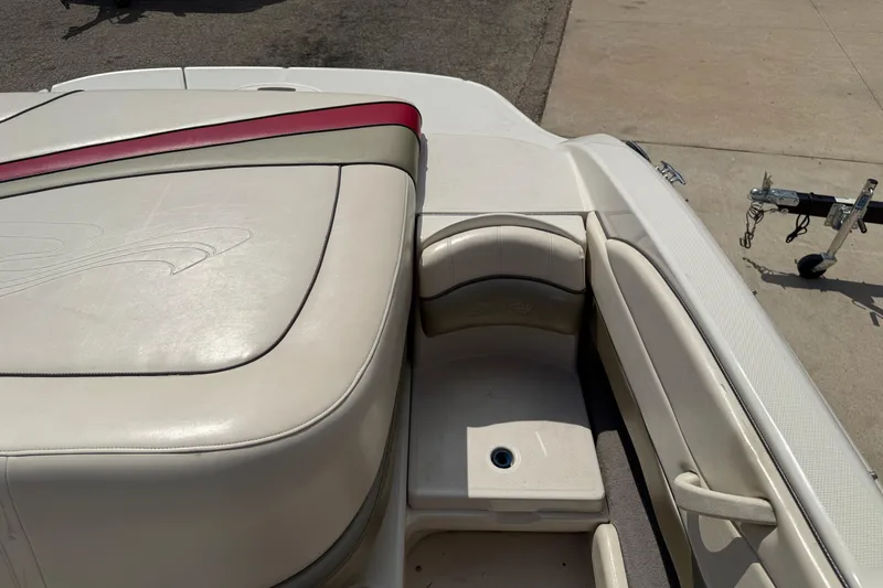 Slide: The Image of 2004 Sea Ray 200 Select boat interior with beige seating and red accents. - 26