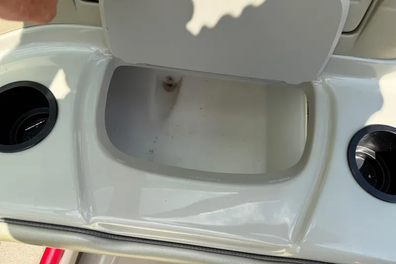 Slide: The Image of Open storage compartment on 2004 Sea Ray 200 Select boat with cup holders. - 28