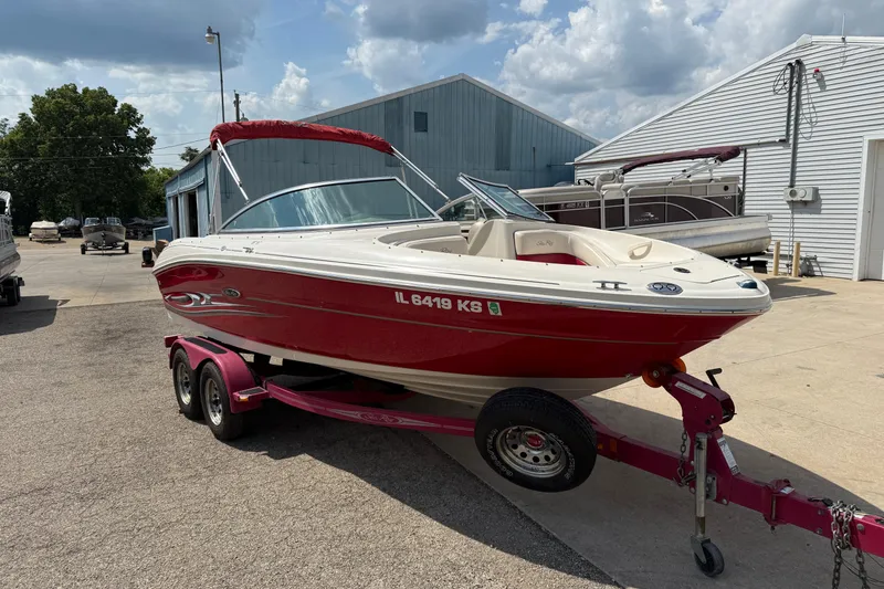 Slide: The Image of 2004 Sea Ray 200 Select boat on trailer, red and white, parked outdoors. - 3