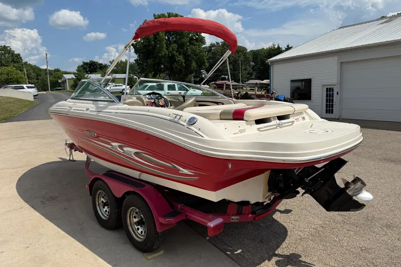 Slide: The Image of 2004 Sea Ray 200 Select boat with red and white design on a trailer. - 7
