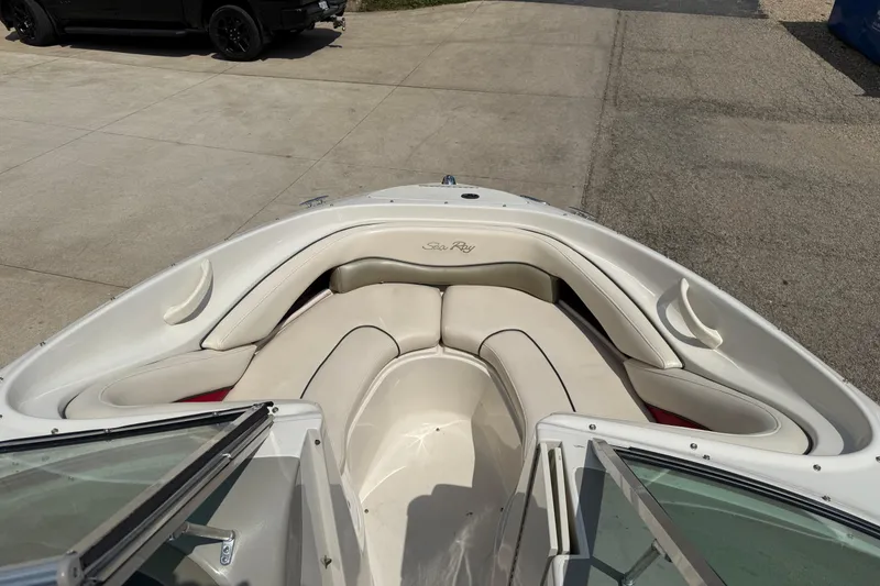 Slide: The Image of 2004 Sea Ray 200 Select boat interior with white seating and open bow design. - 9
