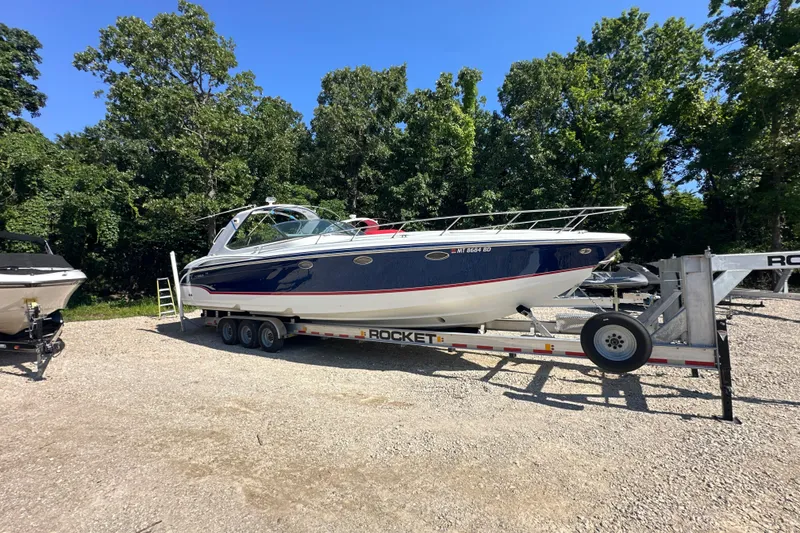 Slide: The Image of 2007 Formula 400 Super Sport boat on trailer, surrounded by trees. - 1