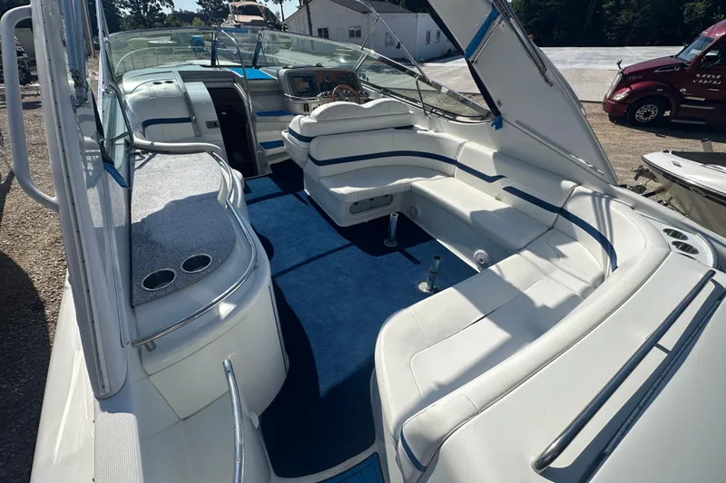 Slide: The Image of 2007 Formula 400 Super Sport boat interior with white seating and blue carpet. - 12