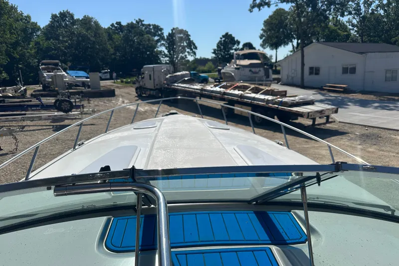 Slide: The Image of 2007 Formula 400 Super Sport boat docked at a marina with surrounding trees. - 14