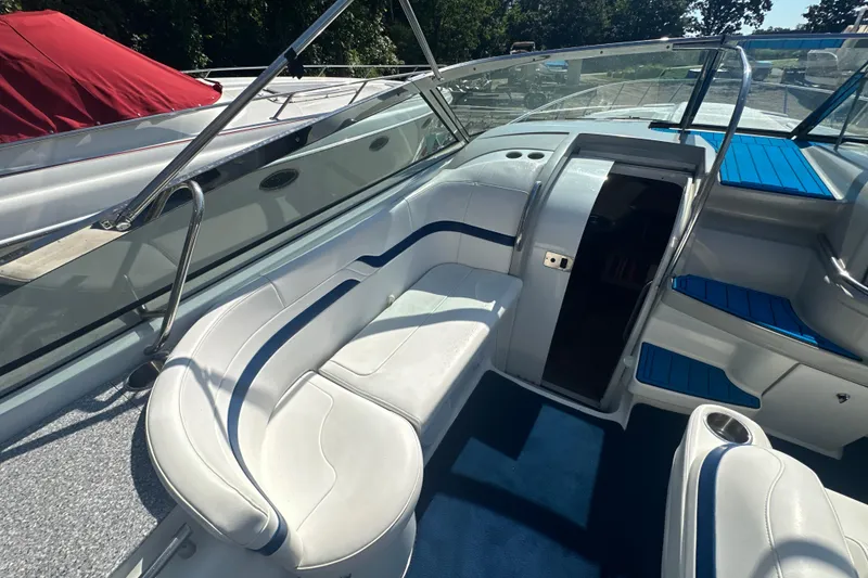 Slide: The Image of 2007 Formula 400 Super Sport boat interior with white seating and blue accents. - 15
