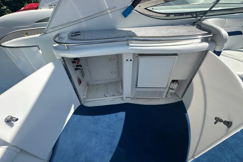 Slide: The Image of 2007 Formula 400 Super Sport boat interior with open storage compartments and blue carpet. - 17
