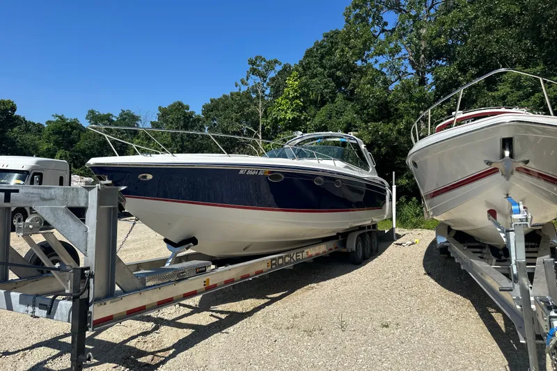 Slide: The Image of 2007 Formula 400 Super Sport boat on trailer, parked outdoors with trees in background. - 2