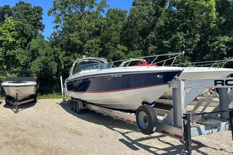 Slide: The Image of 2007 Formula 400 Super Sport boat on trailer, surrounded by trees. - 3