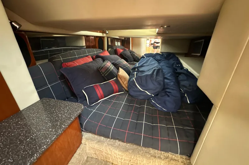 Slide: The Image of Cozy cabin interior of 2007 Formula 400 Super Sport with plaid bedding and pillows. - 37