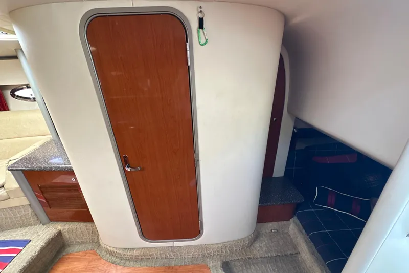 Slide: The Image of Interior of a 2007 Formula 400 Super Sport boat with wooden door and seating area. - 38