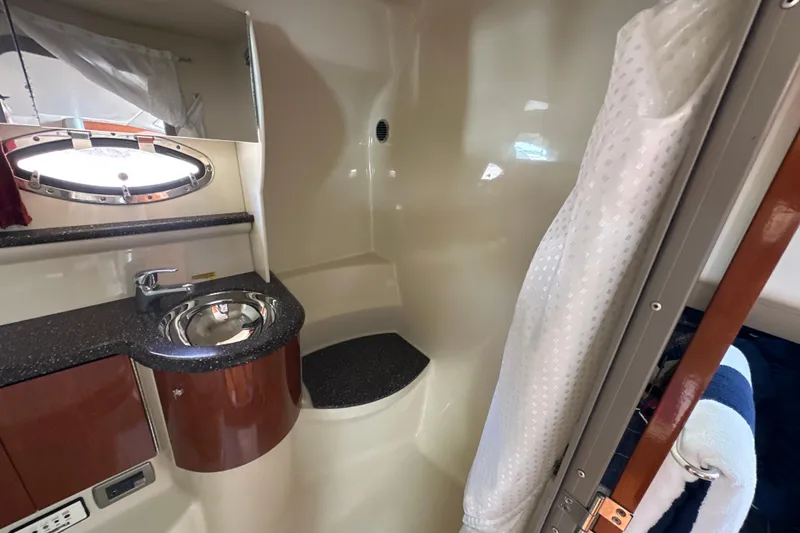 Slide: The Image of 2007 Formula 400 Super Sport bathroom with sink, shower, and porthole window. - 42