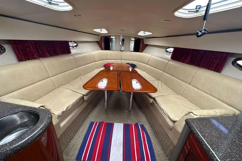 Slide: The Image of Luxurious interior of a 2007 Formula 400 Super Sport yacht with beige seating and wooden table. - 43