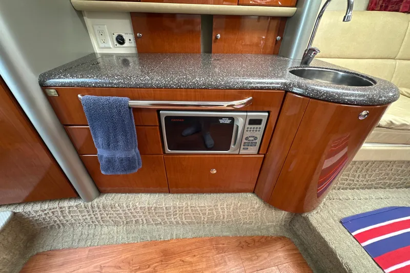 Slide: The Image of 2007 Formula 400 Super Sport yacht interior with kitchenette, featuring microwave and sink. - 46