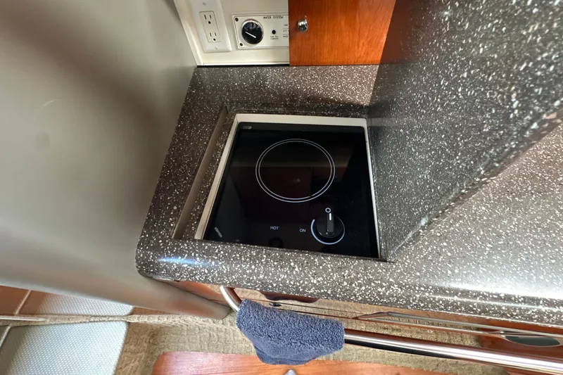 Slide: The Image of 2007 Formula 400 Super Sport yacht kitchen with sleek black cooktop and granite countertop. - 47