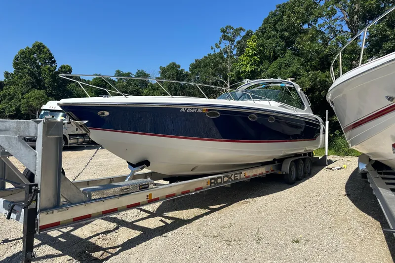 Slide: The Image of 2007 Formula 400 Super Sport boat on trailer, parked outdoors, surrounded by trees. - 5