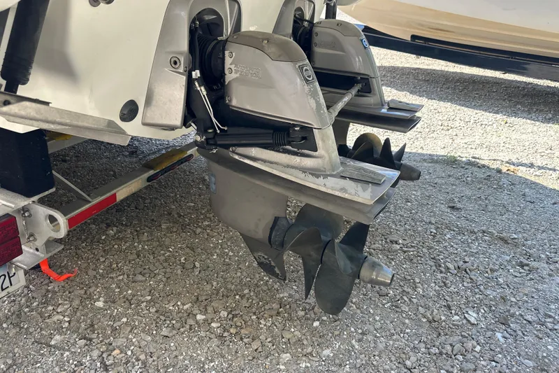 Slide: The Image of 2007 Formula 400 Super Sport boat propellers on a trailer, parked on gravel. - 56